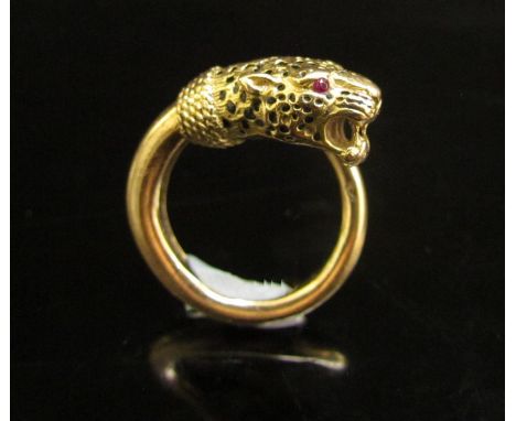 A gold ring stamped 750 with a Panthers head, open mouth with ruby set eyes. Size M, 11g 