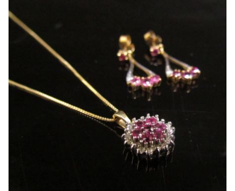 A diamond and ruby cluster pendant hung on a 9ct gold chain, 45cm long and a pair of ruby and diamond drop earrings, 2.4cm dr