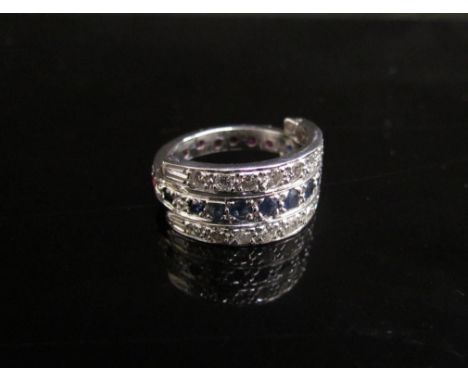 A ruby, sapphire and diamond interchangable ring, the two hinged rows of diamonds can be worn with either the row of rubies o