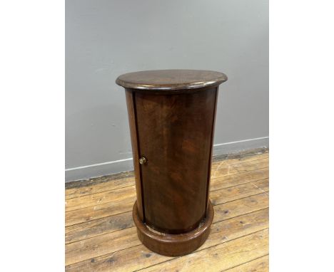 A Victorian mahogany cylinder bedside with circular top with mounded edge enclosing a single fitted shelf on mounded base H x