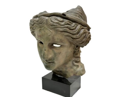 A resin bust after an Ancient Greek model, with helmet mounted on black polymer square base H x 47cm&nbsp; D&nbsp; x 18cm&nbs