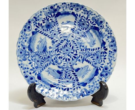 A fine Qing Dynasty Guangxu period Chinese blue and white porcelain Kangxi-revival dish decorated with panels of floral motif