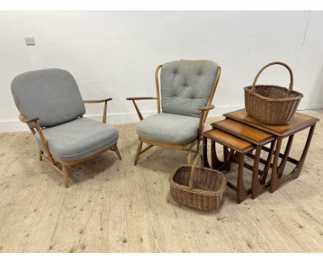 An Ercol 1960s light ash low armchair with later squab cushions on turned tapered splay supports, shows signs of use. H 77cm,