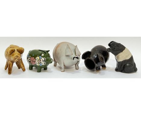 A group of studio pottery and collectible ceramic pigs comprising a Portuguese brown glazed pig, a slip glazed piggy bank, a 
