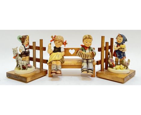 A group of Goebel Hummel figurines comprising a pair of farmyard figures mounted on wooden bases with young boy and girl with