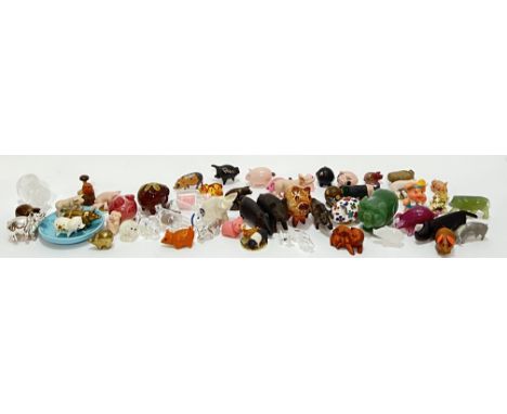 A large quantity of miniature pig ornaments including Jade, lamp work, ceramic, cast metal, tiger's eye, mineral, carved wood