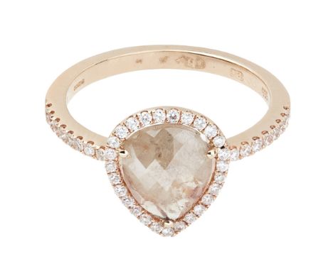 A pear shaped diamond set cluster ringcollet set with a pear shaped rose cut diamond in a border of round-brilliant cut diamo