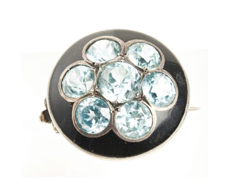 A zircon cluster broochof circular outline, set with seven round cut blue zircons, in a black enamel surround, unmarkedDiamet