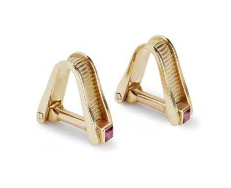 A pair of ruby set gentleman's cufflinkseach of 'V' shaped design with ribbed detail, hinged baton collet set at terminals wi