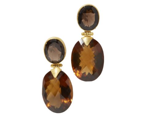 A pair of smokey quartz set pendant earringseach collet set with an oval cut smokey quartz suspending a larger oval mixed-cut