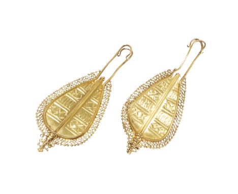 A pair of South East Asian pendant earringseach of tapering drop outline, with hammered geometric design to the centre in a f