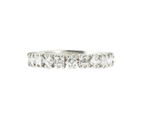 A diamond set half eternity ringclaw set with eleven square baguette cut diamonds at alternating angles, to an 18ct white gol