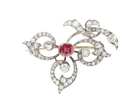 A late 19th century ruby set and diamond set broochmodelled as a flower, collet set with a cushion cut ruby, the scrolling pe