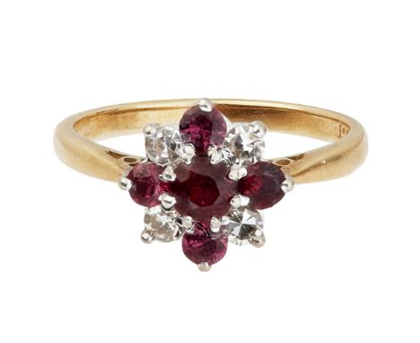 A ruby and diamond set cluster ringclaw set with a round cut ruby in a border of alternating round-brilliant cut diamonds and