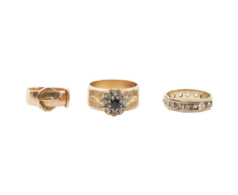 Three gem set ringsto include an 18ct gold ring modelled as a buckle, a 9ct gold sapphire and diamond set cluster ring, and a