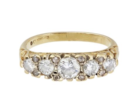 A five stone diamond ringclaw set with five round-brilliant cut diamonds, rose cut diamond detail, pierced scrolling detail t