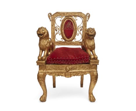 A large silver-gilt throne armchair, India, late 19th century, the rectangular vertical openwork back with oval padded textil