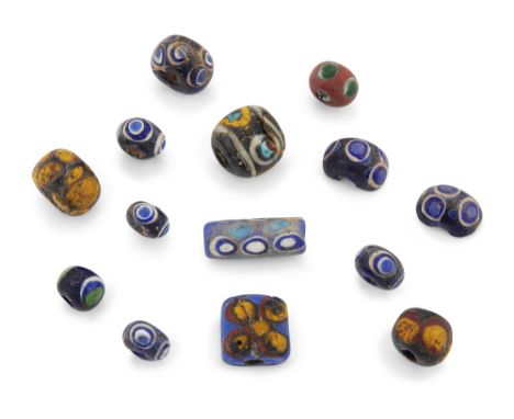 A collection of Roman spherical glass ‘eye’ beads with dark and light blue with white, and later tubular and other polychrome