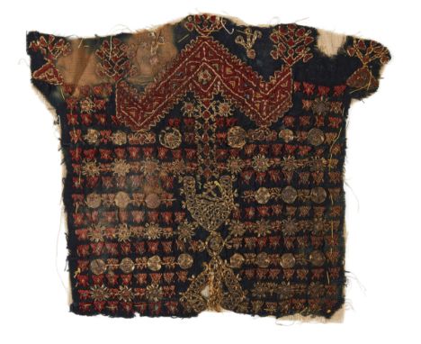 A Mamluk wool tunic fragment, Egypt or North Africa, 14th century, on a blue linen ground, probably the decorative front pane