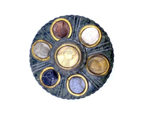 A mid-19th century Italian Grand Tour inkwell, likely Rome or Florence, serpentine, the lid bearing seven brass-mounted cameo