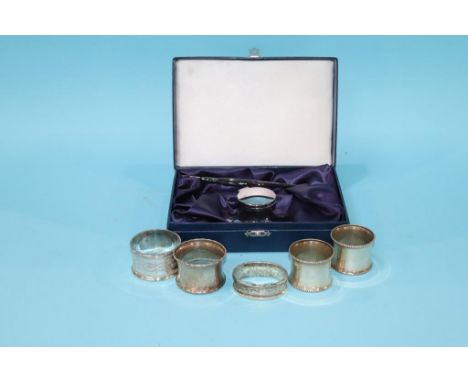 A quantity of silver napkin rings and a cased Capstan inkwell