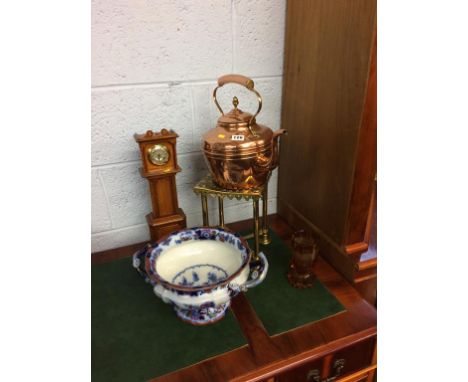 A copper kettle, trivet, clock etc.