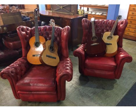 A pair of red Chesterfield button back deep easy armchairs