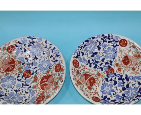 A pair of late 19th century Japanese Imari wall plaques, signed to reverse, 31cm diameter