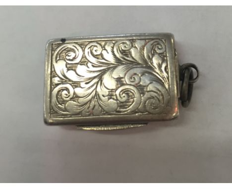 A Victorian silver vinaigrette by George Unite; crisp scroll decoration with pierced gilt floral grill: Birmingham 1899