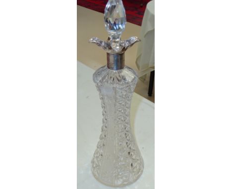 A silver-topped cut glass decanter