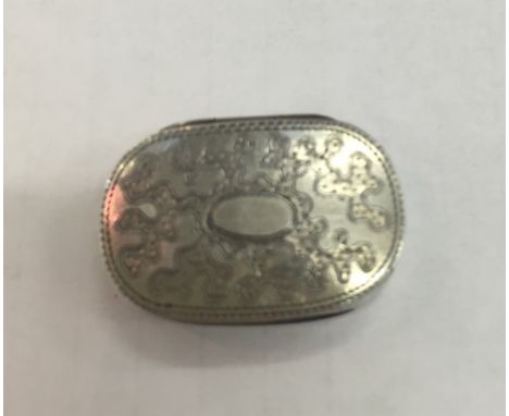 A George III silver vinaigrette of oval form with coral engraving and vacant cartouche, Birmingham 1812: maker's mark 'JW'