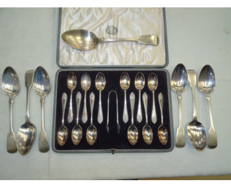 A set of twelve silver teaspoons and sugar tongs; together with seven silver tablespoons