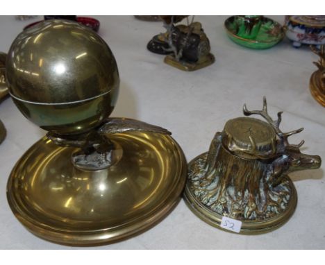 A 19th century brass inkwell in the form of an eagle holding a globe, opening to reveal an inkwell on a circular base; togeth