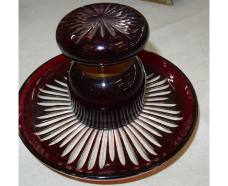 A ruby glass baluster inkwell on a dish-form base