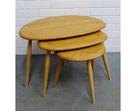 An Ercol nest of three light elm Pebble  tables, on turned tapering supports, 212 x 65cm (3)