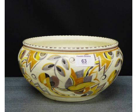 A Poole pottery bowl with yellow and grey stylised painted floral pattern, impressed No.965 to the base, diameter 26cm