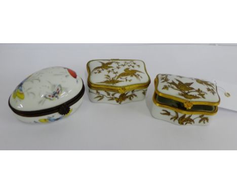 A pair of Limoges porcelain patch / pill boxes with gilt bird and foliage pattern together with a continental porcelain oval 