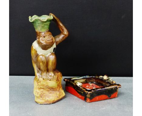 A Sumida Gawa lozenge shaped dish, together with a Japanese pottery monkey candlestick, (2) 