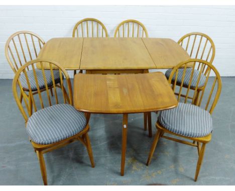 An Ercol light elm Windsor dining suite comprising drop leaf table with additional extension end side table and set of six sp