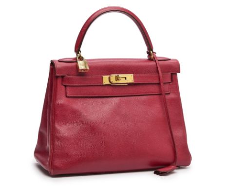 Handtasche "Kelly Bag",Hermès wohl Ende 20. Jh. Rotes, genarbtes Leder, goldfarbene Metall- Elemente. Typ. Form m. 1 Henkel, 