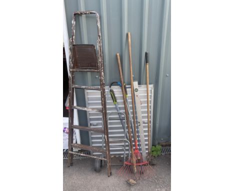 A set of metal ladders, a trolley and a selection of garden tools 