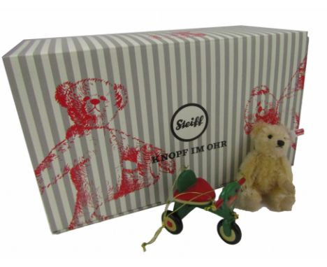 A Steiff 2018 bear Christmas ornament, of a white bear on green bicycle, with label, 13cm high, boxed. 