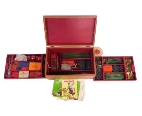 A wooden storage trunk containing a quantity of Meccano, to include Meccano instructions for set 6A, various loose parts, whe