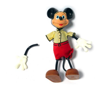 A Marx Toys plastic figure of Mickey Mouse, with bendy arms and legs, 14cm high. 
