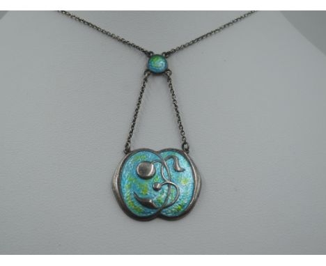 An Art Nouveau silver and enamel pendant by Charles Horner in shades of green and turquoise with enamel connecter to a fixed 