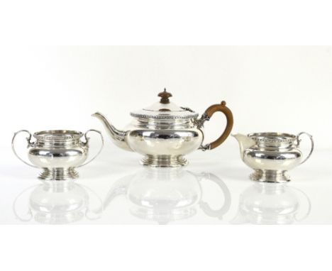 George V silver three-piece tea service, the teapot and cream jug by Stewart Dawson &amp; Co Ltd, London 1927/8, with matchin