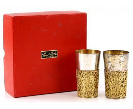 Stuart Devlin, Elizabeth II pair of silver and silver-gilt beakers, the lower body applied with openwork gilt design, London 