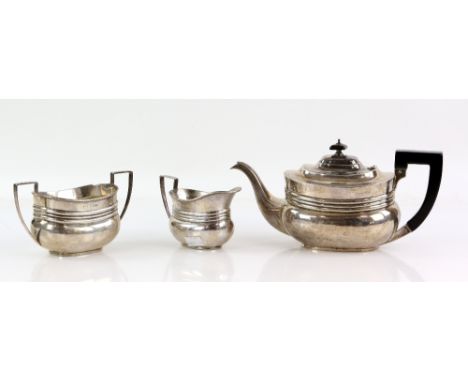 Edward VII three piece silver tea service of compressed oval form, comprising teapot, sugar bowl and cream jug, by Johnson, D