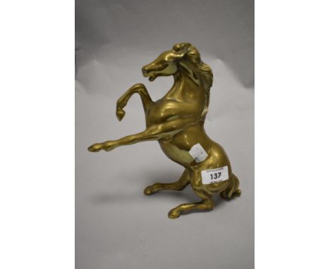 A vintage cast-brass study of a rearing/distressed horse