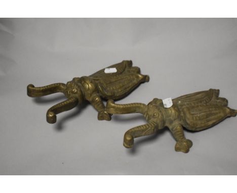 A pair of vintage cast-brass beetle-form boot jacks